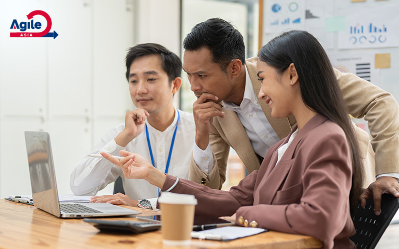 Agile Asia team collaborating on a laptop