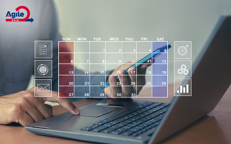 Hand uses phone over laptop with calendar overlay.