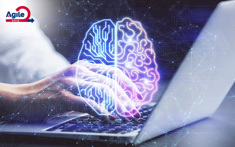 Hands typing on a laptop with a glowing brain graphic symbolizing AI.